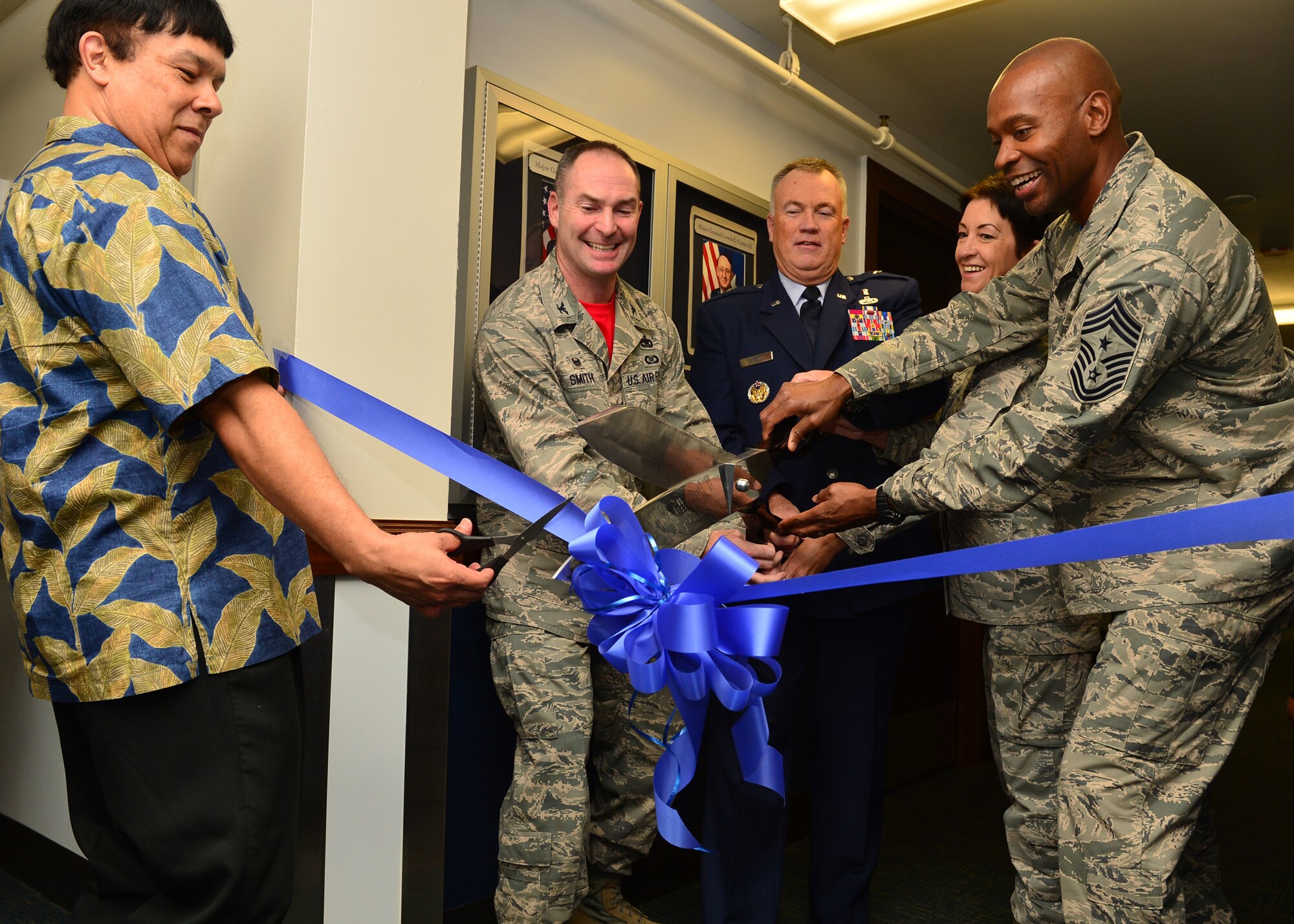 Dr. William Kono, Force Development Flight chief, Col. Richard Smith, 647th Air Base Group commander, Retired Brig. Gen. James Carroll, Hall of Motivation honoree, Lt. Col. Tracy Daniel, 647th Force Support Squadron commander, and Chief Master Sgt. Jerry Williams, 15th Wing command chief, cut the ribbon to reveal the new Hall of Motivation in the 647th Force Support Squadron's education center, on Joint Base Pearl Harbor-Hickam, Feb. 19, 2016. The hallway pays tribute to Air Force members who have begun their careers in the enlisted tier, in pursuit of higher education, and transitioned to the officer corps, eventually rising to the top of their professions as general officers. (U.S. Air Force photo by 2nd Lt. Kaitlin Daddona/Released)