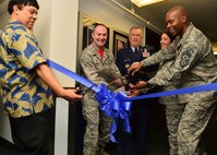 Dr. William Kono, Force Development Flight chief, Col. Richard Smith, 647th Air Base Group commander, Retired Brig. Gen. James Carroll, Hall of Motivation honoree, Lt. Col. Tracy Daniel, 647th Force Support Squadron commander, and Chief Master Sgt. Jerry Williams, 15th Wing command chief, cut the ribbon to reveal the new Hall of Motivation in the 647th Force Support Squadron's education center, on Joint Base Pearl Harbor-Hickam, Feb. 19, 2016. The hallway pays tribute to Air Force members who have begun their careers in the enlisted tier, in pursuit of higher education, and transitioned to the officer corps, eventually rising to the top of their professions as general officers. (U.S. Air Force photo by 2nd Lt. Kaitlin Daddona/Released)