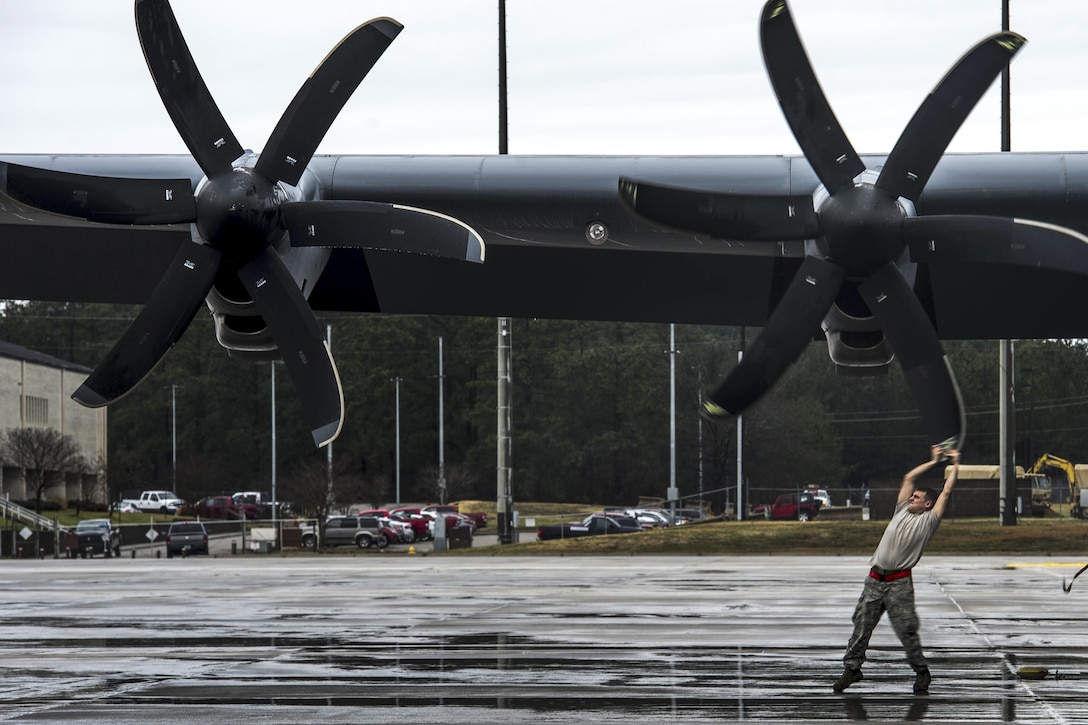 Air Force Senior Airman Thomas Budd turns a propeller on a C-130J Super Hercules aircraft on Pope Army Airfield, N.C., Feb. 4, 2016. Budd is a crew chief assigned to the 19th Aircraft Maintenance Squadron. Air Force photo by Staff Sgt. Marianique Santos