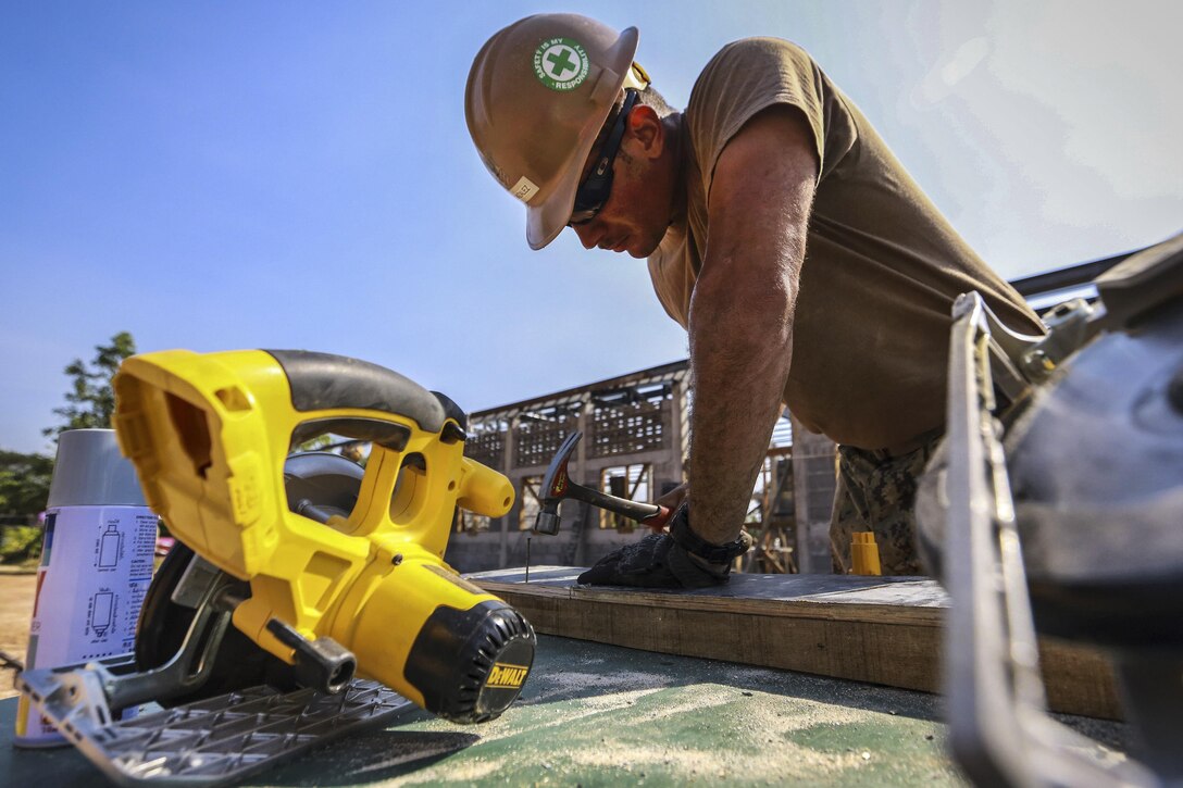 Navy Petty Officer 1st Class Antonio Gonzalez hammers boards while constructing a community center at Ban Sa Yai School during exercise Cobra Gold in Trat, Thailand, Feb. 3, 2016. Gonzalez is a builder assigned to Naval Mobile Construction Battalion 3. Marine Corps photo by Lance Cpl. Miguel A. Rosales
