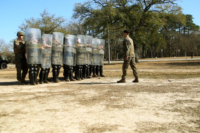 Marines with Combat Logistics Battalion 2 practice formations during non-lethal riot control training at Camp Lejeune, N.C., Feb. 18, 2016. The focus of the training was to teach the Marines to deescalate situations without resulting to weapons that can either injure or kill someone. (U.S. Marine Corps photo by Cpl. Joey Mendez)