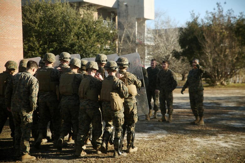 Marines with Combat Logistics Battalion 2 prepare to deescalate a crowd during non-lethal riot control training at Camp Lejeune, N.C., Feb. 19, 2016. The focus of the training was to teach the Marines how to  deescalate situations without resorting to weapons that can injure or kill. (U.S. Marine Corps photo by Cpl. Joey Mendez)