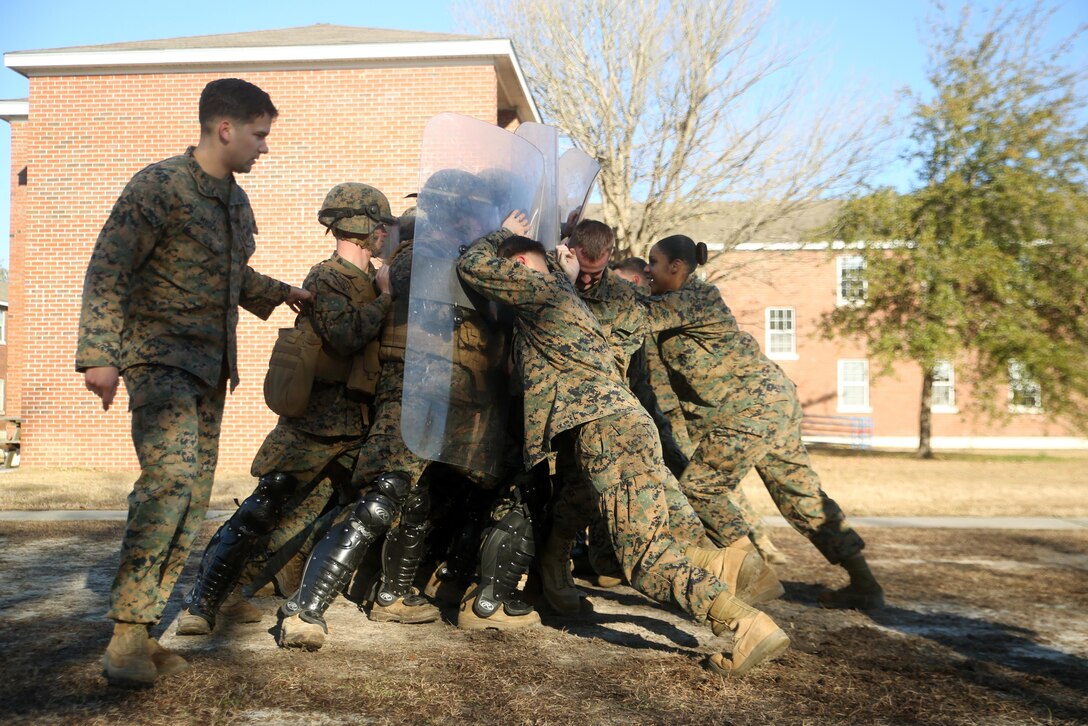 Marines with Combat Logistics Battalion 2 attempt to hold off a crowd during non-lethal riot control training at Camp Lejeune, N.C., Feb. 19, 2016. The training is in preparation for the unit’s upcoming Special Purpose Marine Air-Ground Task Force-Crisis Response-Africa deployment later this year. (U.S. Marine Corps photo by Cpl. Joey Mendez)