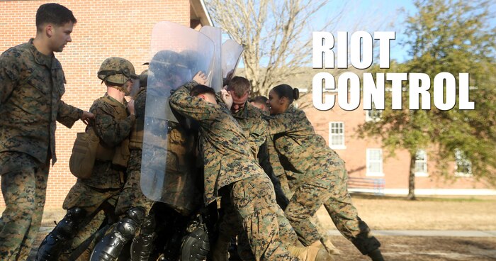 Marines with Combat Logistics Battalion 2 attempt to hold off a crowd during non-lethal riot control training at Camp Lejeune, N.C., Feb. 19, 2016. The training is in preparation for the unit’s upcoming Special Purpose Marine Air-Ground Task Force-Crisis Response-Africa deployment later this year. (U.S. Marine Corps photo illustration by Cpl. Joey Mendez)