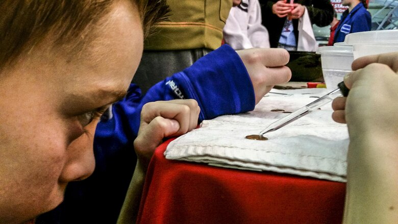 During the penny experiment at the Carnegie Science Center, students to use a water dropper to determine how many water drops they could fit on a single penny. The experiment was used to teach the concept of surface tension.  