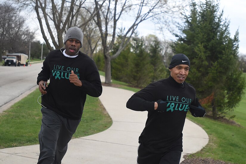 Army Reserve Sgt. 1st Class Terence Barron, left, and Sgt. 1st Class William Keys run in Sunset Meadows Park in Arlington Heights, Ill., during a 5k run/walk, coordinated by the 85th Support Command Sexual Harassment/Assault Response & Prevention Program (SHARP) team, April 22, 2015. The participants ran, despite 37-degree weather, to show their support for Sexual Assault Awareness Month. (Photo by Sgt. Aaron Berogan)