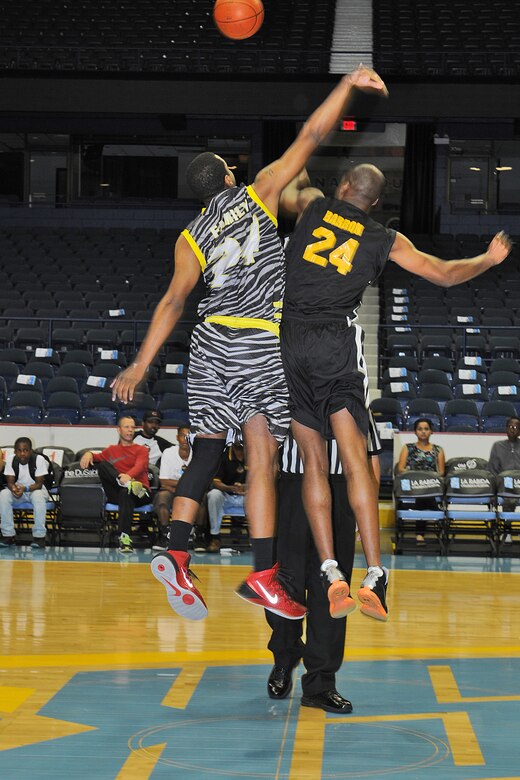 Army Reserve Sgt. 1st Class Terence Baron, right, jumps for a basketball during the opening tip-off at an ‘Army vs. Navy’ exhibition game played at Allstate Arena in Rosemont, Ill. Aug. 30, 2015. The event, hosted by Support All Veterans Equally Foundation and the WNBA’s Chicago Sky basketball team, was part of a pre-game event leading up to the Sky’s game that evening against the Connecticut Sun. Earlier that week, the Chicago Sky partnered up with The Veterans Trust group to host the annual Hoops For Troops Veteran Hiring Expo with an estimated 50 local businesses attended to hire veterans for various positions.(Photo by Spc. David Lietz)