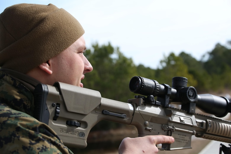 Lance Cpl. Hunter Landrum, a military policeman with Bravo Company, 2nd Law Enforcement Battalion, readies his rifle as a simulated fight starts to escalate during an interior guard training exercise at Forward Observation Base Hawk at Camp Lejeune, N.C., Feb. 17, 2016. The training prepared Marines to conduct real-life site security operations. (U.S. Marine Corps photo by Lance Cpl. Erick Galera/Released)