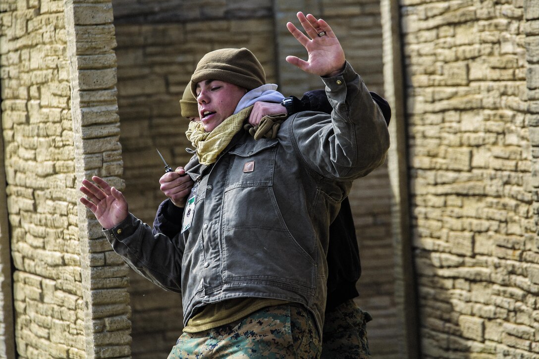 Marines with Bravo Company, 2nd Law Enforcement Battalion, simulate civilians initiating altercations at a forward observation base, which requires Marines to step in and take control of the situation during an interior guard training exercise at Forward Observation Base Hawk at Camp Lejeune, N.C., Feb. 17, 2016. The training prepared Marines to conduct real-life site security operations. (U.S. Marine Corps photo by Lance Cpl. Erick Galera/Released)