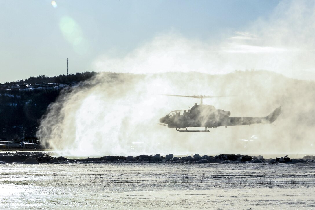 A Marine Corps AH-1W Super Cobra helicopter kicks up snow in Vaernes, Norway, Feb. 22, 2016, as the 2nd Marine Expeditionary Brigade prepares for Exercise Cold Response. The joint exercise includes about 16,000 troops and 12 NATO allies and partnered nations. Marine Corps photo by Cpl. Dalton A. Precht