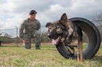 Senior Airman Jordan Fuller, 802nd Security Forces Squadron military working dog handler, and his MWD, Rocco, perform maneuvers Feb. 23, at Joint Base San Antonio-Lackland Medina Annex. Handlers regularly practice obedience training with their working dogs to increase their team cohesiveness. (U.S. Air Force photo by Johnny Saldivar/released) 