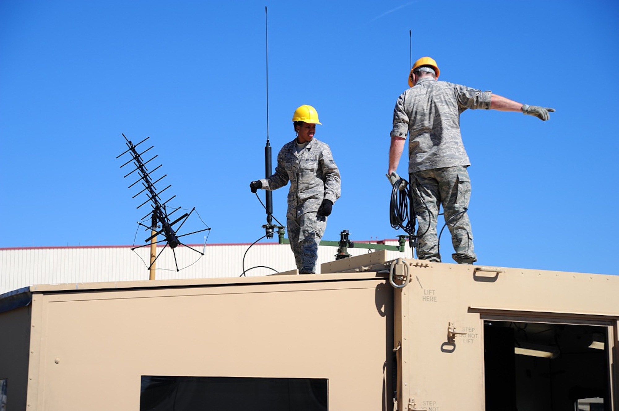 Members of the 315th Airlift Control Flight install communication equipment on top of the HELAMS during training exercise Patriot Sands Feb. 17, 2016, at Hunter Army Airfield, Georgia. (U.S. Air Force Photo by Senior Airman Jonathan Lane)