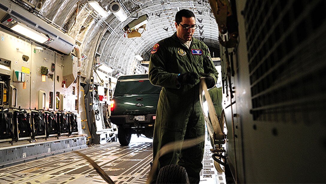 Senior Airman Christiane Rowman, 315th Airlift Control Flight loadmaster, straps down equipment in a C-17 Globemaster III during training exercise Patriot Sands Feb. 17, 2016, at Hunter Army Airfield, Georgia. (U.S. Air Force Photo by Senior Airman Jonathan Lane)