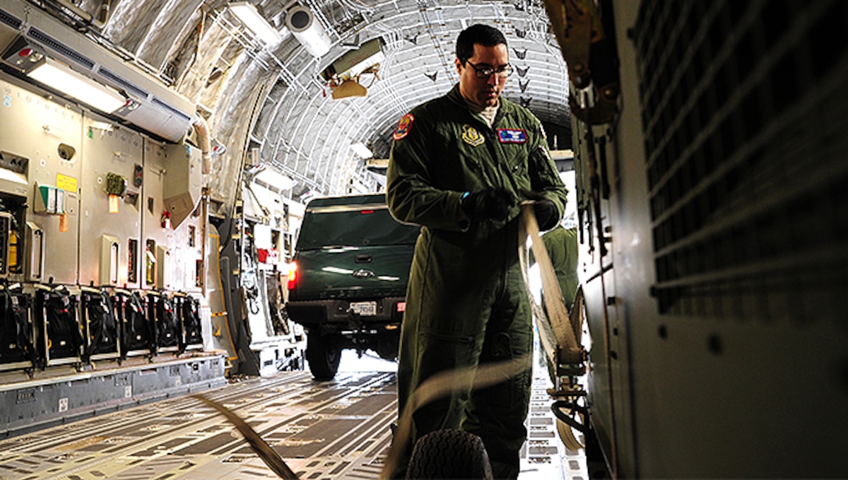 Senior Airman Christiane Rowman, 315th Airlift Control Flight loadmaster, straps down equipment in a C-17 Globemaster III during training exercise Patriot Sands Feb. 17, 2016, at Hunter Army Airfield, Georgia. (U.S. Air Force Photo by Senior Airman Jonathan Lane)
