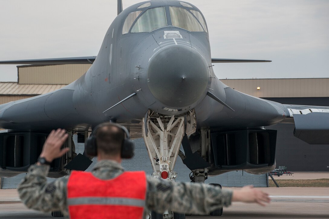 U.S. Air Force Tech. Sgt. Jesse Walters, a crew chief assigned to the 489th Maintenance Squadron, marshals a 7th Bomb Wing B-1 Lancer from its parking spot in support of a training mission on Feb. 20, 2016, Dyess Air Force Base (AFB), Texas. The 489th MXS is assigned to the Air Force Reserve Command’s 489th Bomb Group at Dyess, which assigned to the 307th Bomb Wing at Barksdale Air Force Base, La. (U.S. Air Force photo by Master Sgt. Greg Steele/Released)