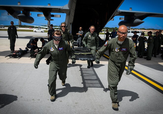 An aeromedical evacuation team of the Royal Australian and U.S. Air Force rushes to transfer a patient with simulated injuries from a U.S. Navy MH-60S Seahawk Feb. 17, 2016, at Andersen Air Force Base, Guam. Exercise Cope North 16 enhances humanitarian assistance and disaster relief crisis response capabilities between six nations and lays the foundation for regional cooperation expansion during real-world contingencies in the Indo-Asia-Pacific Region. 