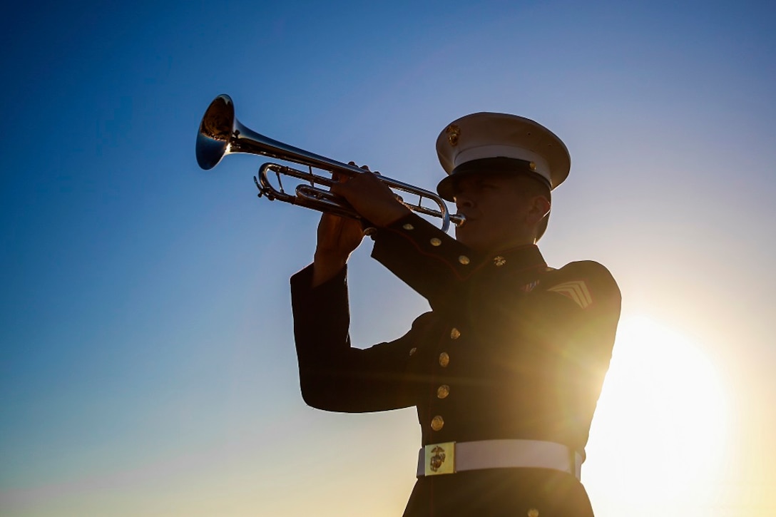 Sgt. Gregg Alvarez plays Taps during the sunset memorial for the 71st anniversary of the Battle of Iwo Jima, Feb. 20 at Camp Pendleton, Calif. During the 36-day battle for the 8.5 square-mile island, 6,821 Marines gave their lives to gain control of the strategic position in the Pacific during World War II. Alvarez, from Harlingen, Texas, is a musician with the 1st Marine Division Band, I Marine Expeditionary Force. (U.S. Marine Corps photo by Lance Cpl. Caitlin Bevel)