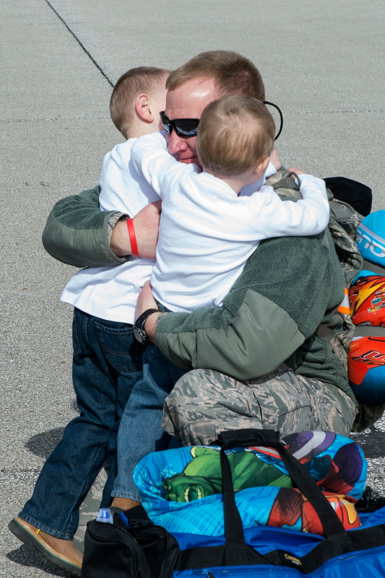 Staff Sgt. Patrick Marchman, 434th Aircraft Maitenance integrated avionics specialist, embraces his children, Kellen and Caden, after returning to Grissom Air Reserve Base, Ind., Feb. 7, 2016 following a deployment to Southwest Asia. In addition to family members, other Airmen and leadership from Grissom stood by to greet the returning deployers following a 4-month deployment in support of Operation Inherent Resolve. (U.S. Air Force photo/Tech. Sgt. Benjamin Mota)