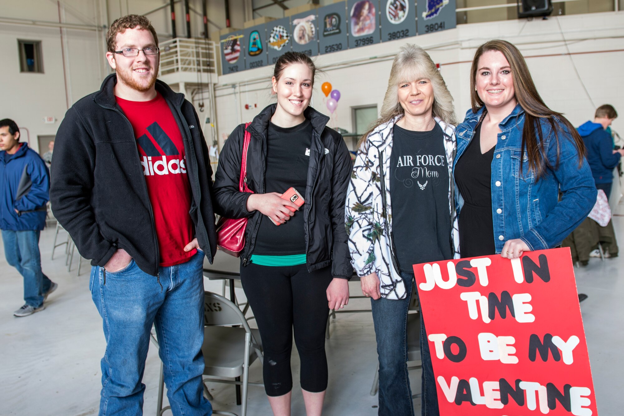 From left to right, Ethan Drabenstot, Anna Drabenstot, Diane Snead and Katherine Fruit, hold a sign to welcome home Senior Airman Brian Snead, 434th Aircraft Maintenance Squadron crew chief, prior to his arrival at Grissom Air Reserve Base, Ind., Feb. 7, 2016.  A total of 68 Airmen returned from a 4-month deployment to Southwest Asia in support of Operation Inherent Resolve. (U.S. Air Force photo/Tech. Sgt. Benjamin Mota)