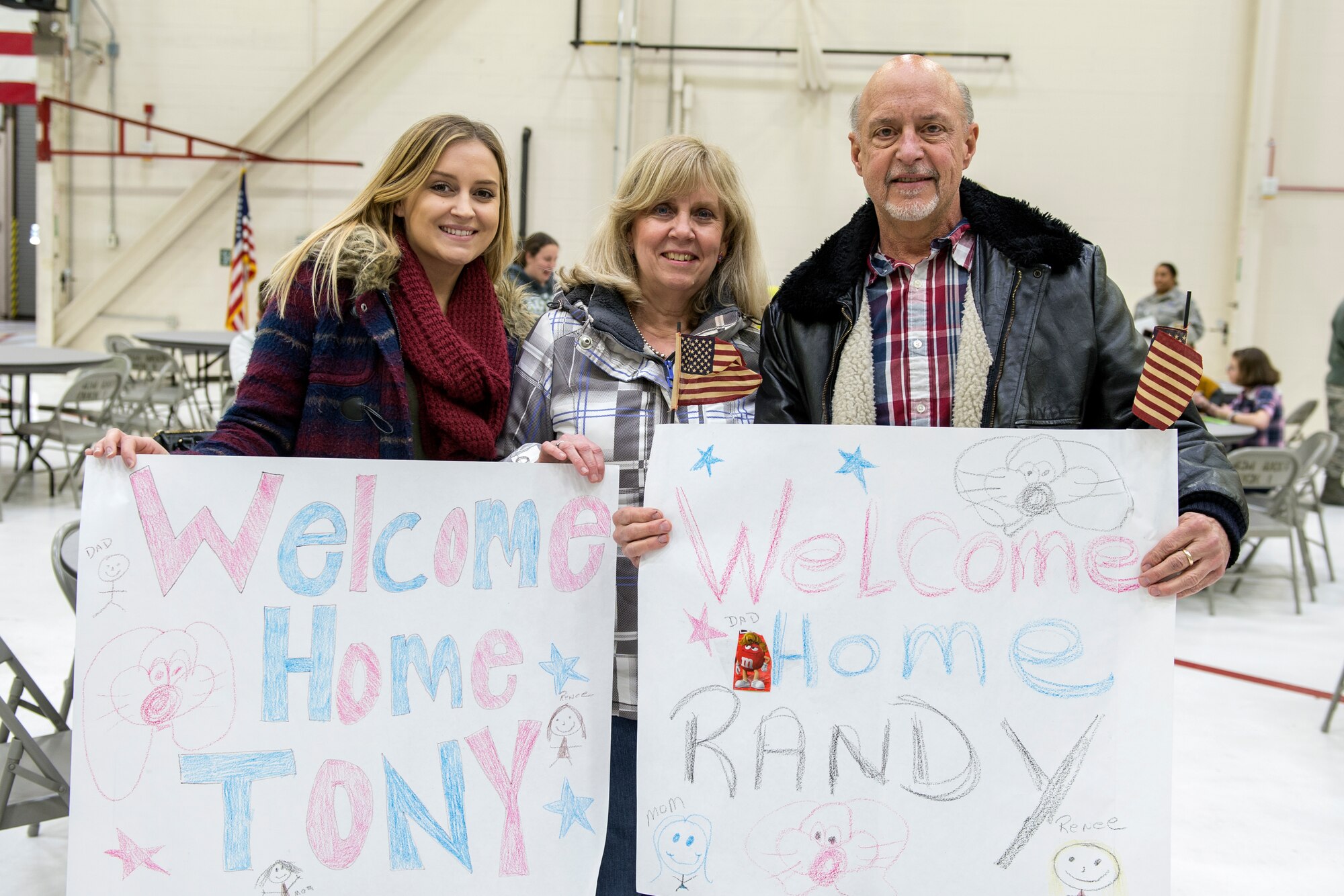From left to right, Rene, Kathy and Randy Morelli hold a sign for Senior Airman Anthony Morelli, 434th Maintenance Squadron aircraft fuel systems specialist, prior to his arrival at Grissom Air Reserve Base, Ind., Feb. 7, 2016. Moorelli and 67 others Airmen returned from a 4-month deployment to Southwest Asia in support of Operation Inherent Resolve. 