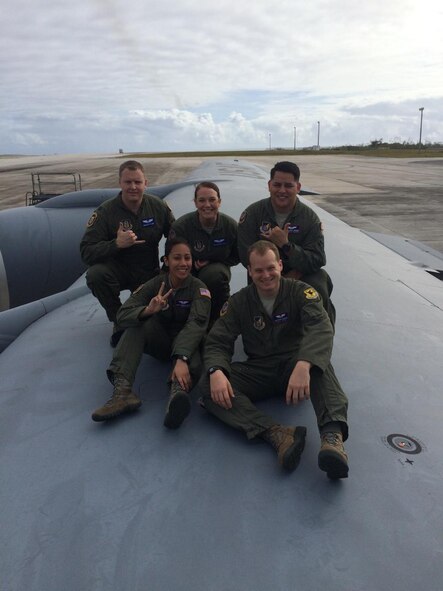 Capt. Bradley Stone, top left, and Senior Airman Samantha Strom, top middle, both assigned to the 932nd Aeromedical Evacuation Squadron at Scott Air Force Base, pose with fellow medical aircrew members while on a temporary assignment to Hawaii.  Stone and Strom both rushed to aid survivors of a downed helicopter that crashed into Pearl Harbor, Feb. 18, 2016, Honolulu Hawaii. (Courtesy photo)