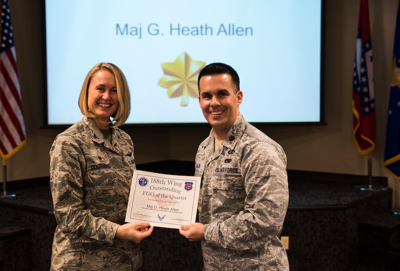 Maj. Heath Allen, 188th Wing executive officer, accepts the Outstanding Field Grade Officer of the Quarter award from Col. Bobbi Doorenbos, 188th Wing commander, Feb. 20, 2016, during a commander’s call at Ebbing Air National Guard Base, Fort Smith, Ark. The Outstanding FGO award is given to FGOs that have provided exceptional service to the wing throughout the last quarter and distinguished themselves among the best in the 188th. Winners were selected in the Airman, Noncomissioned Officer, Senior NCO, Company Grade Officer and FGO categories. (U.S. Air National Guard photo by Senior Airman Cody Martin/Released)