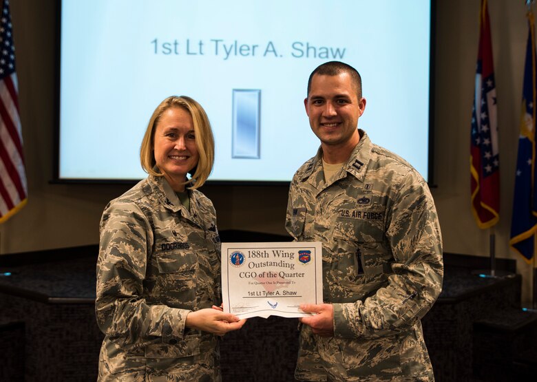 Capt. Tyler Shaw, 188th Medical group physician assistant, accepts the Outstanding Company Grade Officer of the Quarter award from Col. Bobbi Doorenbos, 188th Wing commander, Feb. 20, 2016, during a commander’s call at Ebbing Air National Guard Base, Fort Smith, Ark. The Outstanding CGO of the Quarter award is given to  CGOs that have provided exceptional service to the wing throughout the last quarter and distinguished themselves among the best in the 188th. Winners were selected in the Airman, Noncomissioned Officer, Senior NCO, CGO and Field Grade Officer categories. (U.S. Air National Guard photo by Senior Airman Cody Martin/Released)