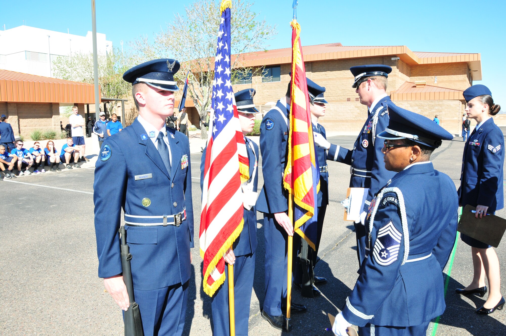 Members of the 161st Air Refueling Wing color guard inspect a Junior Reserve Officer Training Corps color guard during the West-Mitchell Invitational Drill Meet in Phoenix, Feb. 20. (U.S. Air National Guard photo by Master Sgt. Charles Wade)