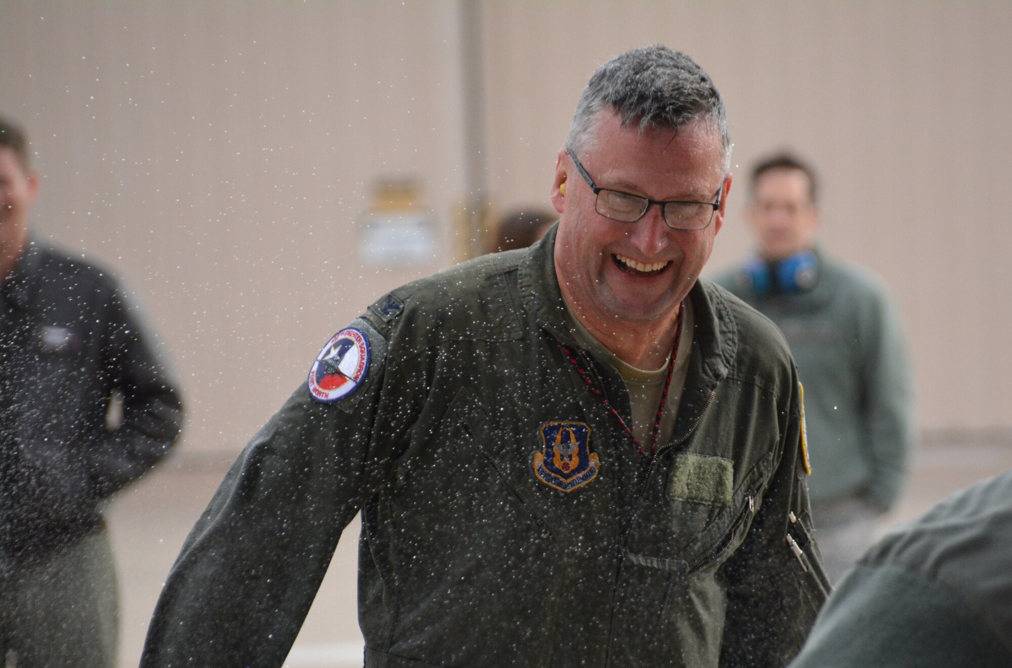 NAVAL AIR STATION FORT WORTH JOINT RESERVE BASE, Texas -- Col. Robert Buchanan, 301st Fighter Wing vice commander, is all smiles here after his final return from the skies Feb. 6 as an Air Force pilot. Buchanan’s family and friends celebrated a time-honored tradition of spraying water on a pilot after he’s completed his “fini-flight”. (U.S. Air Force photo by Staff Sgt. Samantha Mathison)