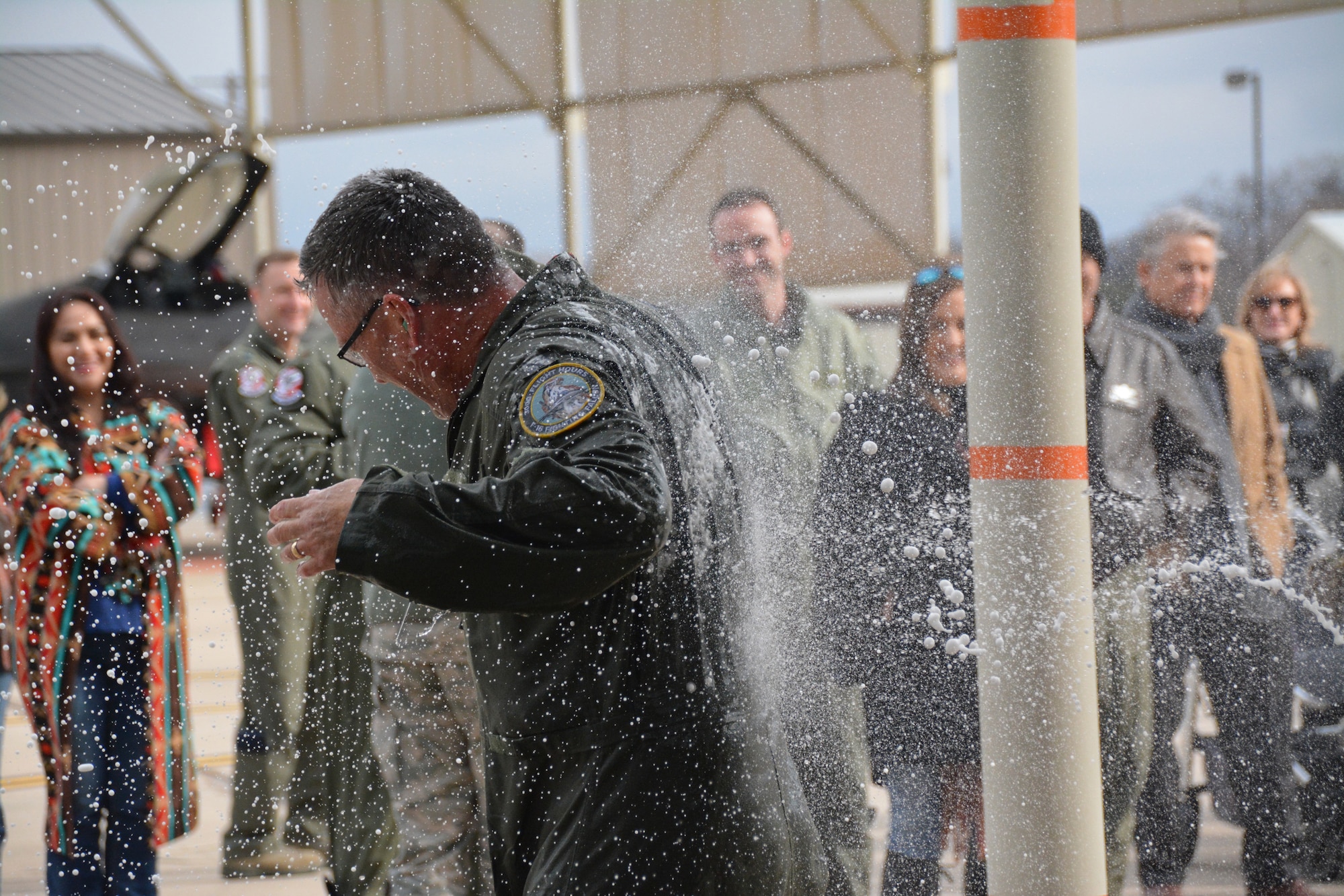 NAVAL AIR STATION FORT WORTH JOINT RESERVE BASE, Texas – Col. Robert Buchanan, 301st Fighter Wing vice commander, is sprayed with water after he disembarked his jet from his “fini-flight”, Feb. 6. Buchanan celebrated with friends and family after his final return from the skies as an Air Force pilot. (U.S. Air Force photo by Staff Sgt. Samantha Mathison)