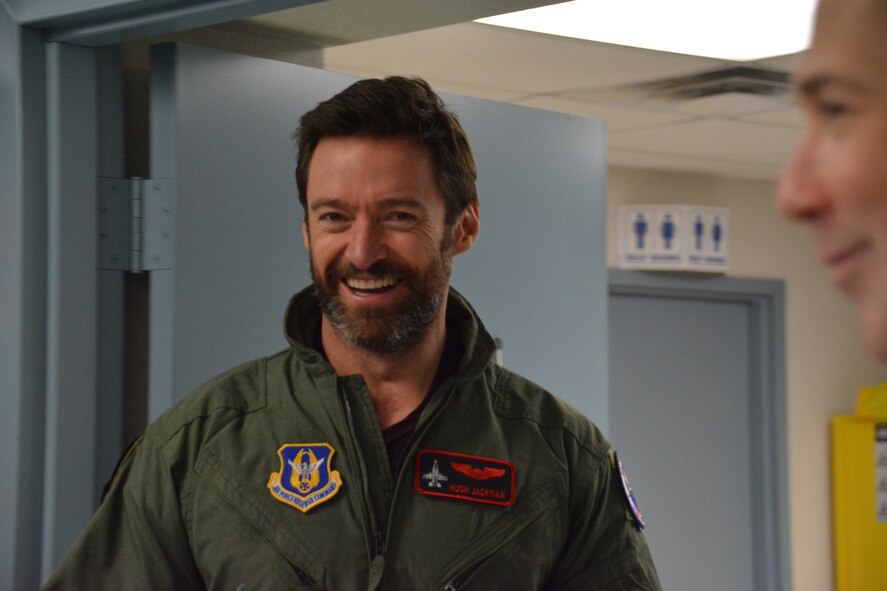 NAVAL AIR STATION FORT WORTH JOINT RESERVE BASE, Texas – Hugh Jackman, “Eddie the Eagle” star, is all smiles Feb. 19 while getting ready for his flight here in an F-16. Jackman, along with co-star Taron Egerton and director Dexter Fletcher, met with service members and their families before showing a sneak preview of their movie “Eddie the Eagle” at the base theater. (U.S. Air Force photo by Staff Sgt. Samantha Mathison)