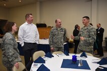 Team McChord members talk to Tom Embleton, FedEx Senior Manager and 62nd Aerial Port Squadron Honorary Commander, during the Team McChord Honorary Commander change of command at the McChord Chapel Support Center Feb. 22, 2016, at Joint Base Lewis-McChord, Wash. More than 15 civic leaders and community partners were teamed up this year with Team McChord commanders to gain insight about the Air Force and the mission here. (U.S. Air Force photo/Staff Sgt. Naomi Shipley)