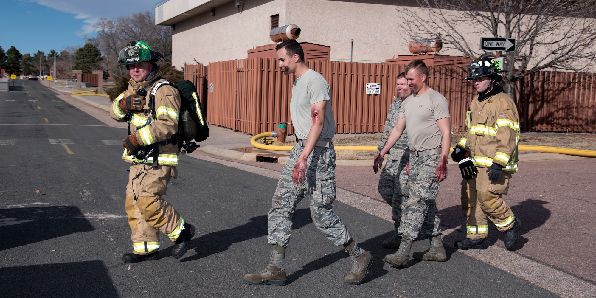 PETERSON AIR FORCE BASE, Colo. – Peterson firefighters evacuate role players while performing recovery operations following a simulated building explosion and resulting fire here during the 16-2 Condor Crest Exercise on Feb. 18, 2016. The exercise tested the 21st Space Wing and associate units’ response to several incidents during the week-long exercise. (U.S. Air Force photo by Craig Denton)