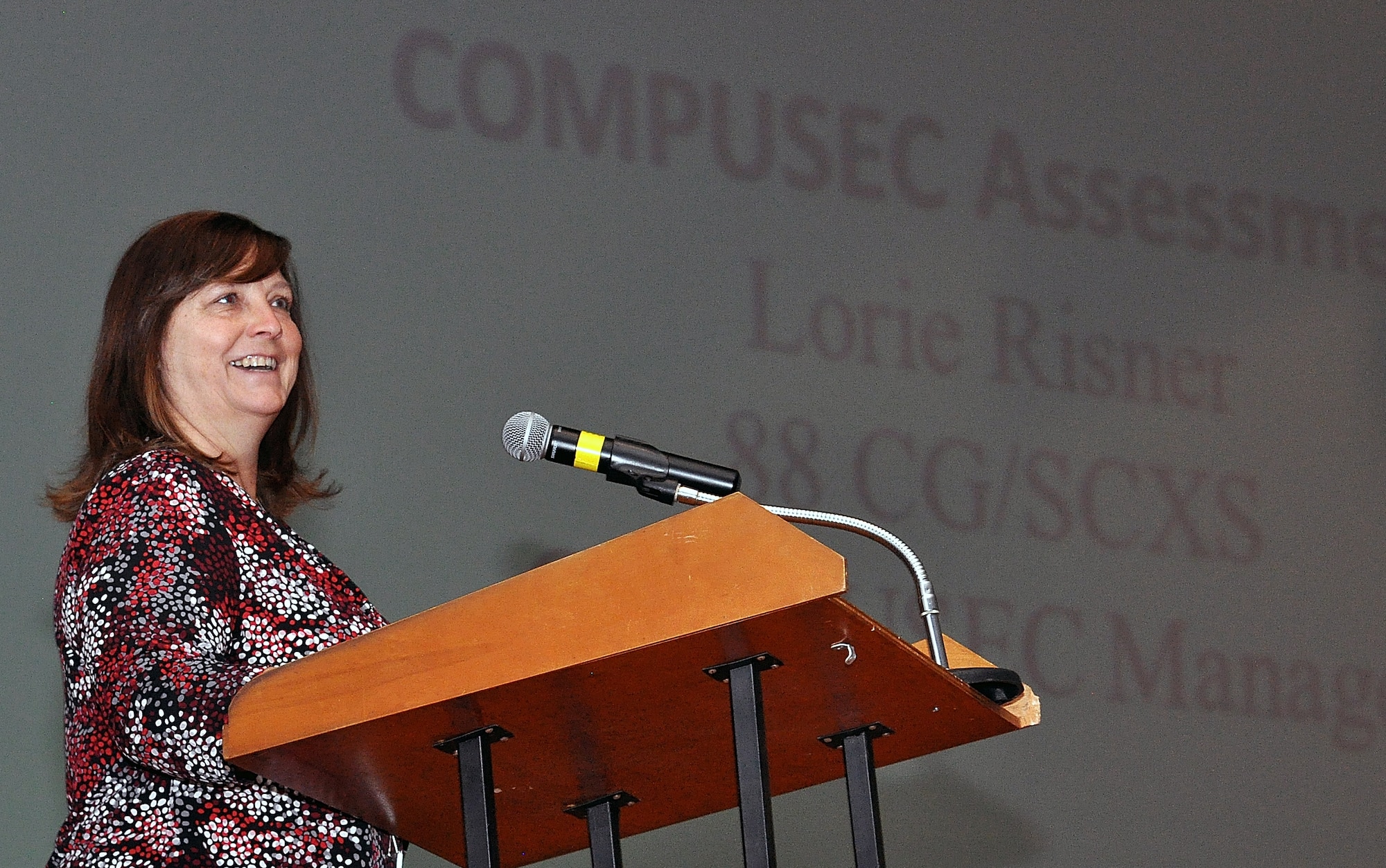 At the Wright-Patterson AFB 88th Communications Group Cyber Forum, Lorie Risner, 88th CG, focuses her remarks on an upcoming computer security, or COMPUSEC, assessment. Risner was among a dozen presenters at the quarterly Cyber Forum which brings base Information Technology professionals together to discuss issues, as well as upcoming events, which will impact them as they service the base's IT needs. U.S. Air Force photo by William Huntington