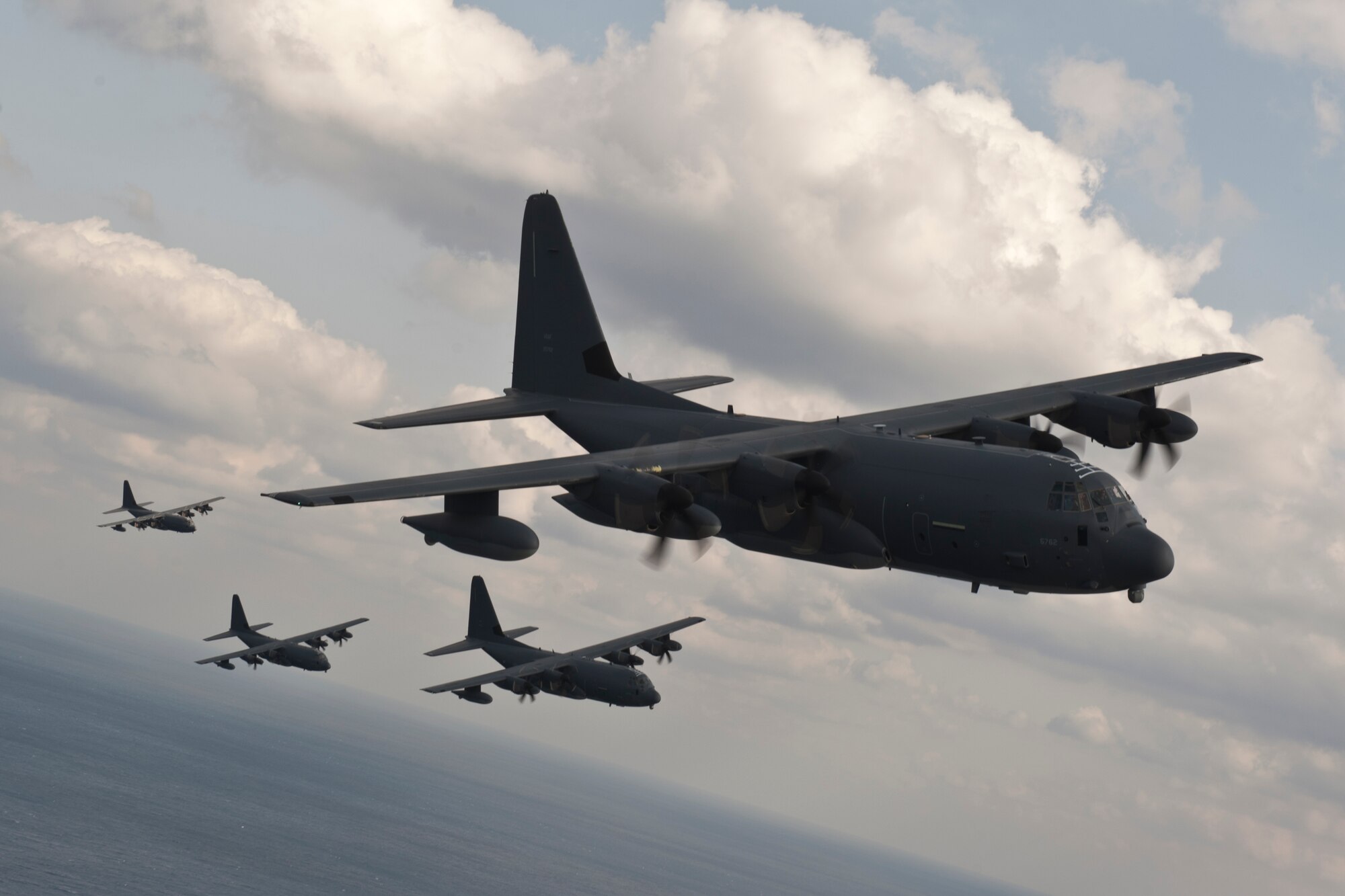 U.S. Air Force MC-130J Command II's assigned to the 17th Special Operations Squadron fly in formation Feb. 17, 2016, off the coast of Okinawa, Japan. The 17th SOS conducted a unit-wide training exercise which tasked the entire squadron with a quick-reaction, full-force sortie involving a five-ship formation flight, cargo drops, short runway landings and takeoff, and helicopter air-to-air refueling. (U.S. Air Force photo by Senior Airman Peter Reft)
