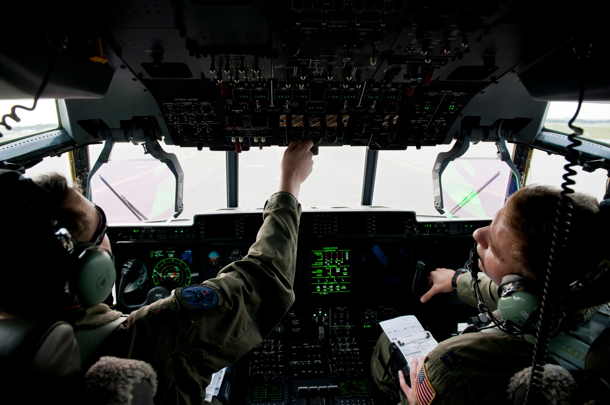 U.S. Air Force Maj. Brad Talley, 17th Special Operations Squadron MC-130J Commando II instructor pilot, and Capt. Jerome Harms, 17th SOS MC-130J pilot, run through a pre-flight checklist during a training exercise Feb. 17, 2016, at Kadena Air Base, Japan.  Talley and Harms piloted the lead aircraft in a five-ship formation flight. (U.S. Air Force photo by Senior Airman Peter Reft)