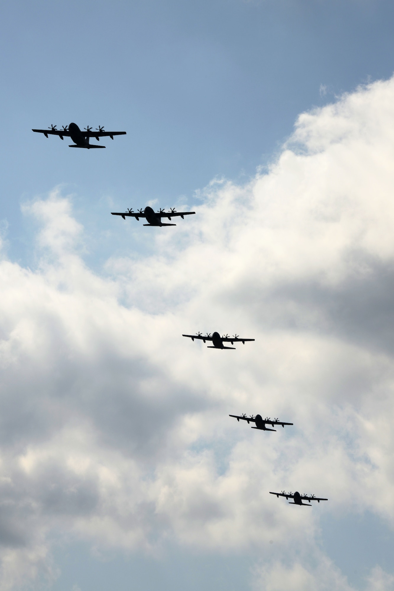 U.S. Air Force MC-130J Command II's assigned to the 17th Special Operations Squadron fly in formation Feb. 17, 2016, over Kadena Air Base, Japan. The 17th SOS conducted a unit-wide training exercise which tasked the entire squadron with a quick-reaction, full-force sortie involving a five-ship formation flight, cargo drops, short runway landings and takeoffs, and helicopter air-to-air refueling. (U.S. Air Force photo by Master Sgt. Kristine Dreyer)