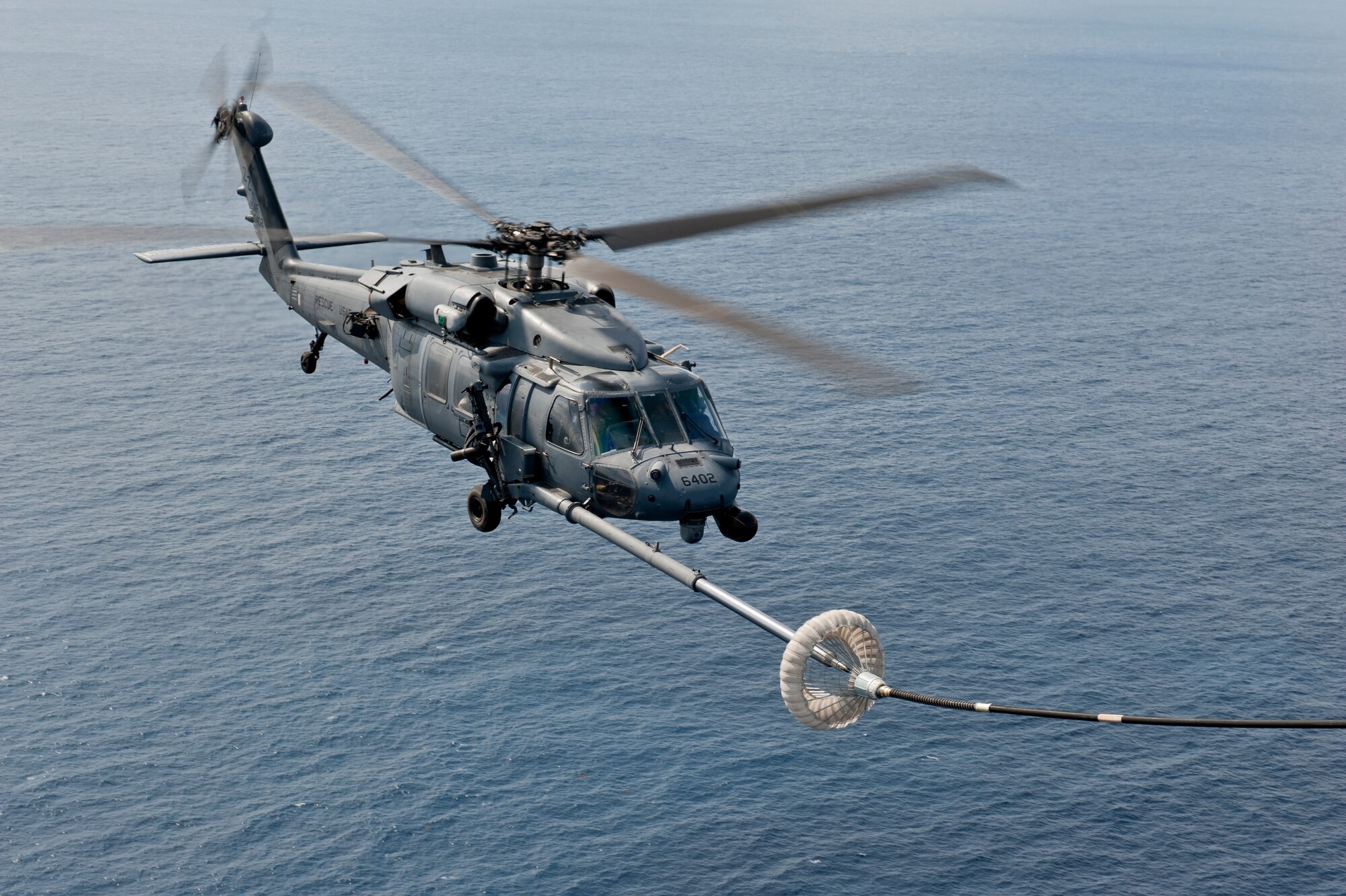 A U.S. Air Force HH-60G Pave Hawk helicopter assigned to the 33rd Rescue Squadron performs in-flight refueling during a training exercise Feb. 17, 2016, off the coast of Okinawa, Japan. The 33rd RS performs military personnel recovery, civil search and rescue, medical evacuation, disaster response, and humanitarian assistance. (U.S. Air Force photo by Senior Airman Peter Reft)