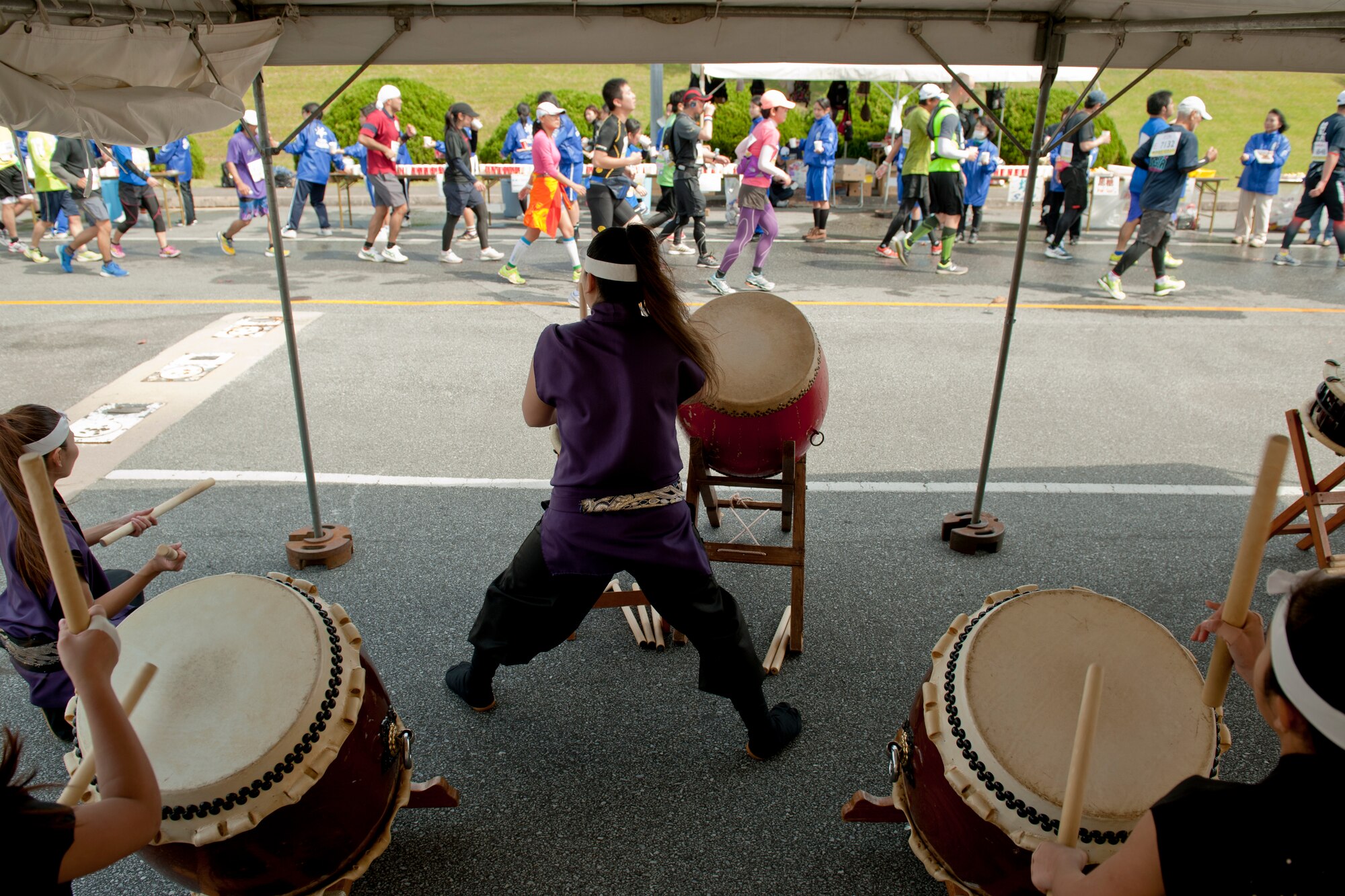 Soukan Taiko members play drums to cheer on runners during the Okinawa Marathon Feb. 21, 2016, at Kadena Air Base, Japan. Drummers played and sang for nearly three hours as approximately 9,000 runners passed through Kadena's two-kilometer section of the marathon. (U.S. Air Force photo by Senior Airman Peter Reft)