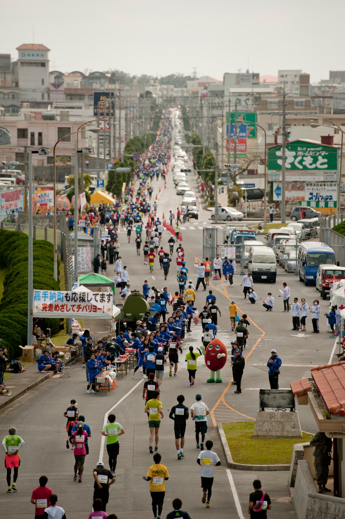 Marathon runners exit gate five during the Okinawa Marathon Feb. 21, 2016 at Kadena Air Base, Japan. 11,330 people participated in the full marathon and 8,918 people finished the goal in a time limit within 6 hours 15 minutes. (U.S. Air Force photo by Senior Airman Peter Reft)