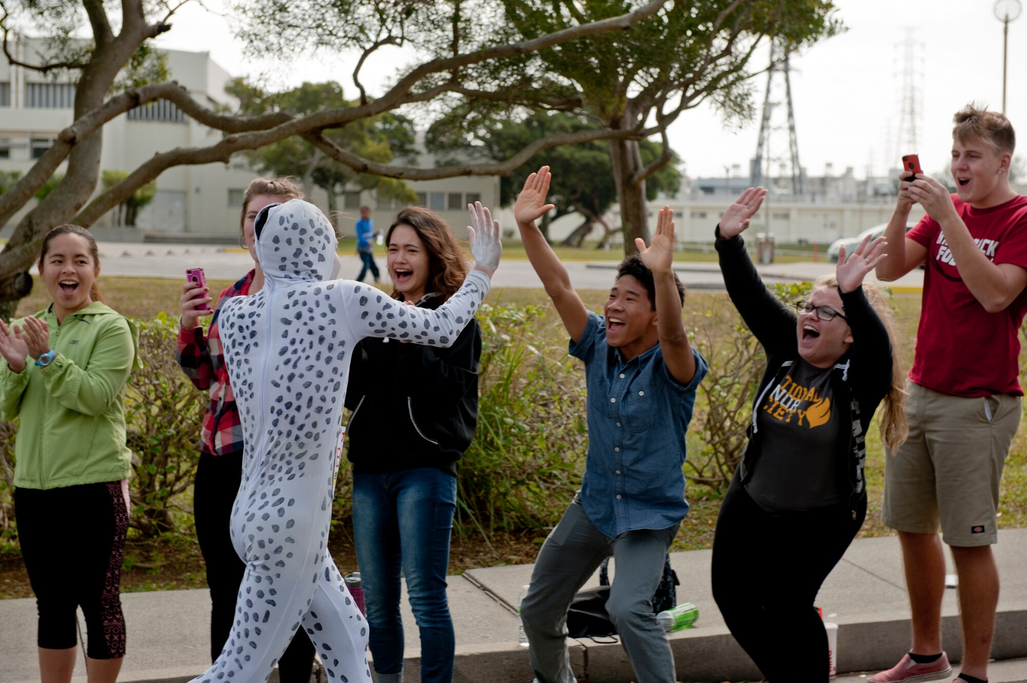 A runner exchanges high-fives with Team Kadena family members during the Okinawa Marathon Feb. 21, 2016, at Kadena Air Base, Japan. The annual Okinawa Marathon is one of two full marathons in Okinawa, covering a distance of 42.195 kilometers. (U.S. Air Force photo by Senior Airman Peter Reft)