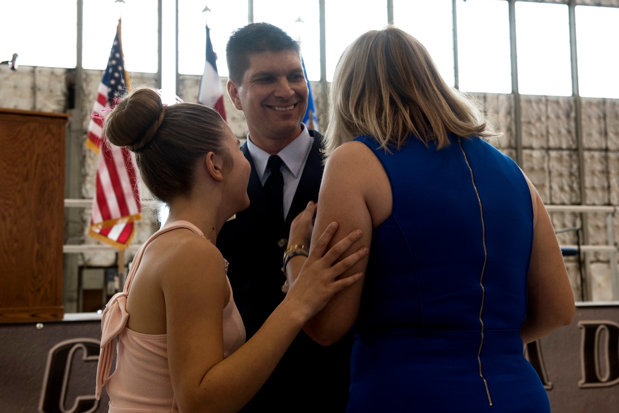 Lt. Col. Paul Feichtinger celebrates with his wife and daughter after taking command of the 120th Fighter Squadron, 140th Wing, Colorado Air National Guard on February 20, 2015. (U.S. Air National Guard photo by Staff Sgt. Michelle Alvarez-Rea)