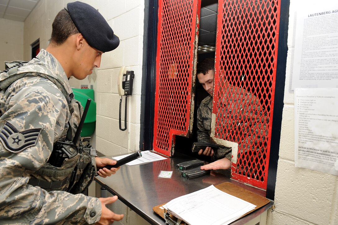 U.S. Air Force Senior Airman Michael Baliatico, 633rd Security Forces Squadron installation entry controller, returns equipment to Senior Airman Jared Brubaker, 633rd SFS armorer, at Langley Air Force Base, Va., Feb. 17, 2016. The armorers check all received equipment to ensure nothing is missing or broken. (U.S. Air Force photo by Senior Airman Brittany E. N. Murphy)