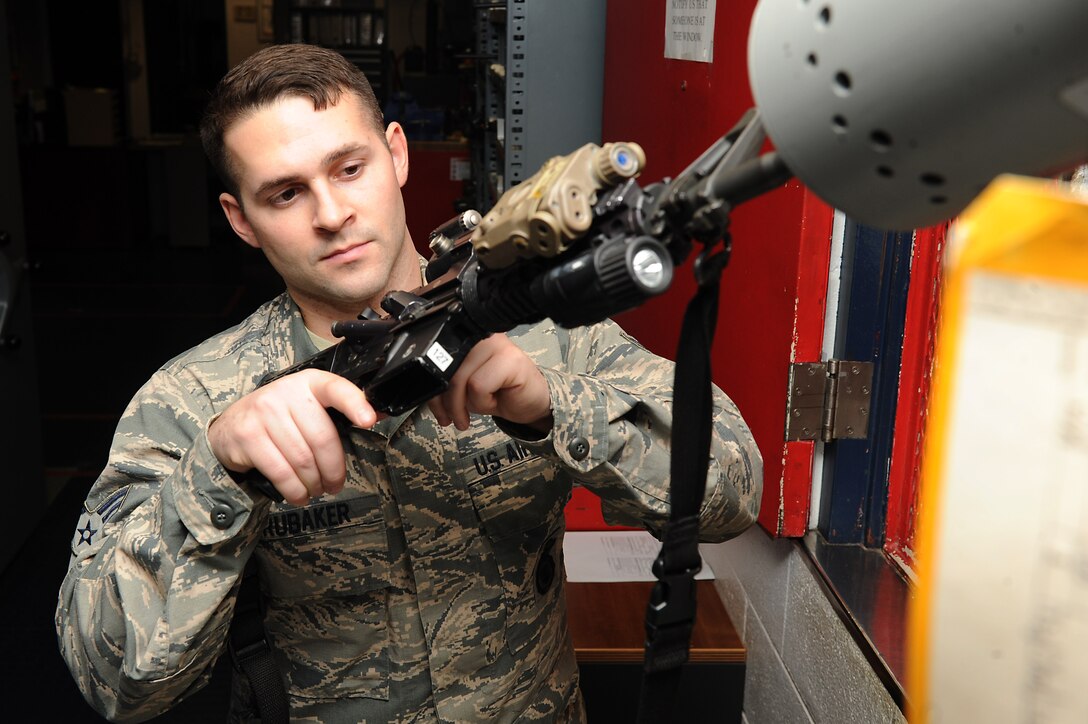 U.S. Air Force Senior Airman Jared Brubaker, 633rd Security Forces Squadron armorer, checks an M-4 Carbine chamber to ensure it is clear of ammunition prior to issuing at Langley Air Force Base, Va., Feb. 17, 2016. The armory is in charge of issuing gear to SFS personnel on duty, privately owned fire arms of dorm residents, as well as SF personnel firing at the range. (U.S. Air Force photo by Senior Airman Brittany E. N. Murphy)