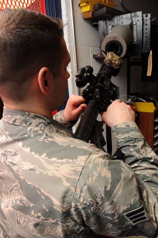 U.S. Air Force Senior Airman Jared Brubaker, 633rd Security Forces Squadron armorer, clears an M-4 Carbine prior to issuing at Langley Air Force Base, Va., Feb. 17, 2016. Each weapon is checked to ensure they are clear of ammunition and are safe for handling. (U.S. Air Force photo by Senior Airman Brittany E. N. Murphy)