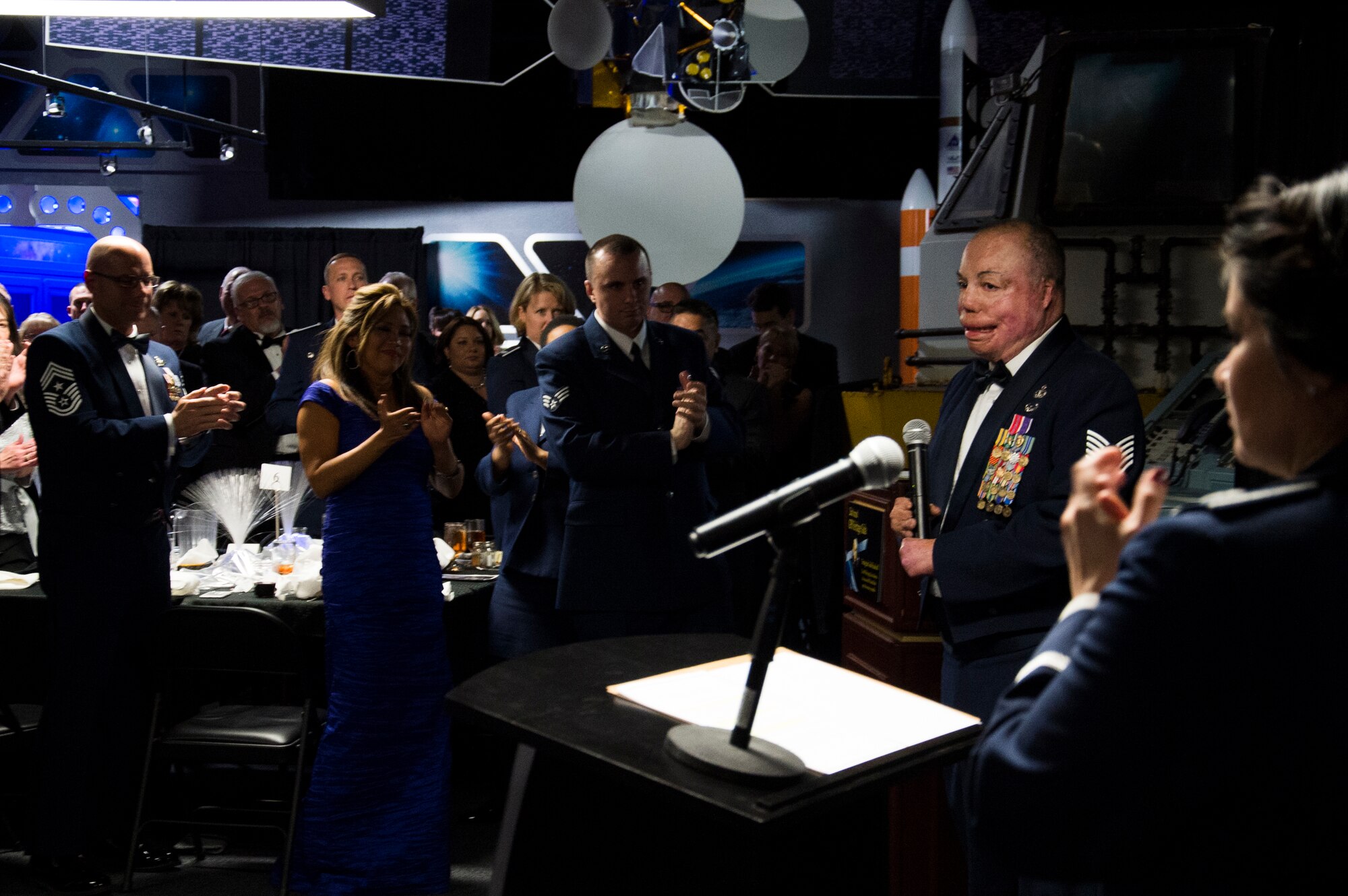 Attendees give a standing ovation to Tech. Sgt. Israel Del Toro Jr. after sharing his story during the GPS Heritage Gala Friday, Feb. 19, 2016, at the Space Foundation in Colorado Springs, Colorado. Del Toro was the guest speaker during the event, which celebrated the space program’s achievement and the men and women who made them possible. (U.S. Air Force photo/Tech. Sgt. Julius Delos Reyes)