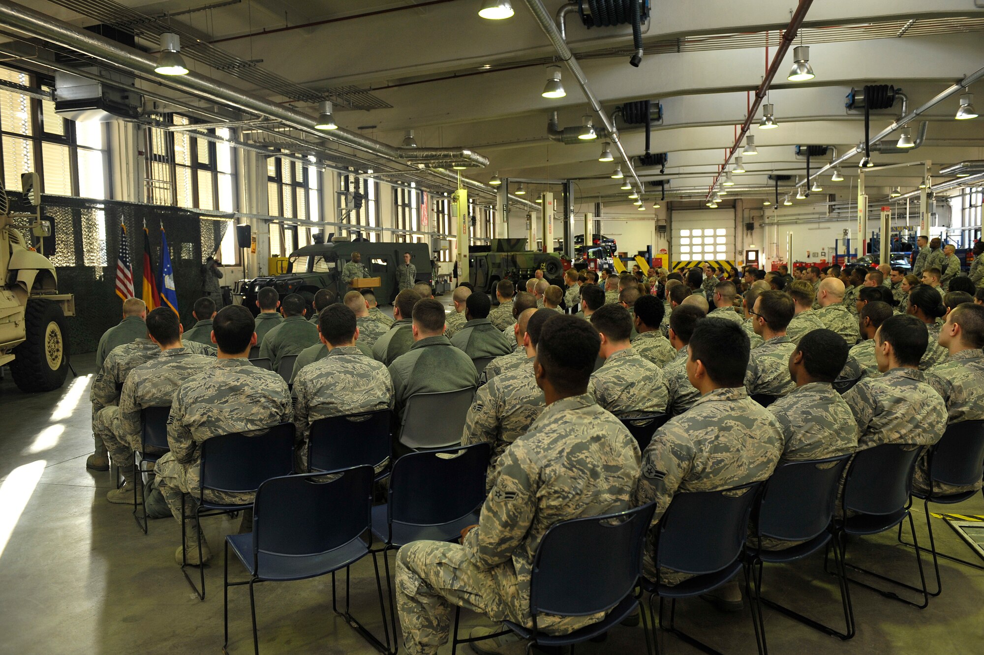 Airmen and family members listen as Col. Lawrence Hicks, 86th Logistics Readiness Group commander, speaks during a Homefront Heroes ceremony Feb. 19, 2016, at Ramstein Air Base, Germany. Hicks spoke about his appreciation to the deployed members and their families for their strength and commitment. (U.S. Air Force photo/Airman 1st Class Larissa Greatwood)