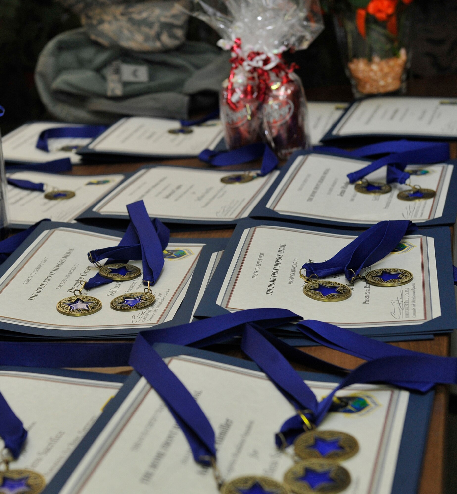 Awards for family members of deployment returnees lay on a table display at a Homefront Heroes ceremony Feb. 19, 2016, at Ramstein Air Base, Germany. The event recognized the sacrifices made by families while deployed members were away. (U.S. Air Force photo/Airman 1st Class Larissa Greatwood) 