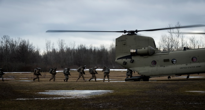 Soldiers from C Troop 2/101 Cavalry, from Buffalo, simulate breaking contact and boarding a U.S. Army CH-47 Chinook helicopter for extraction, Youngstown, NY, Feb. 20, 2016. The Soldiers are training in preparation for larger scale exercises to be held throughout the year. (U.S. Air National Guard photo by Staff Sgt. Ryan Campbell/Released)