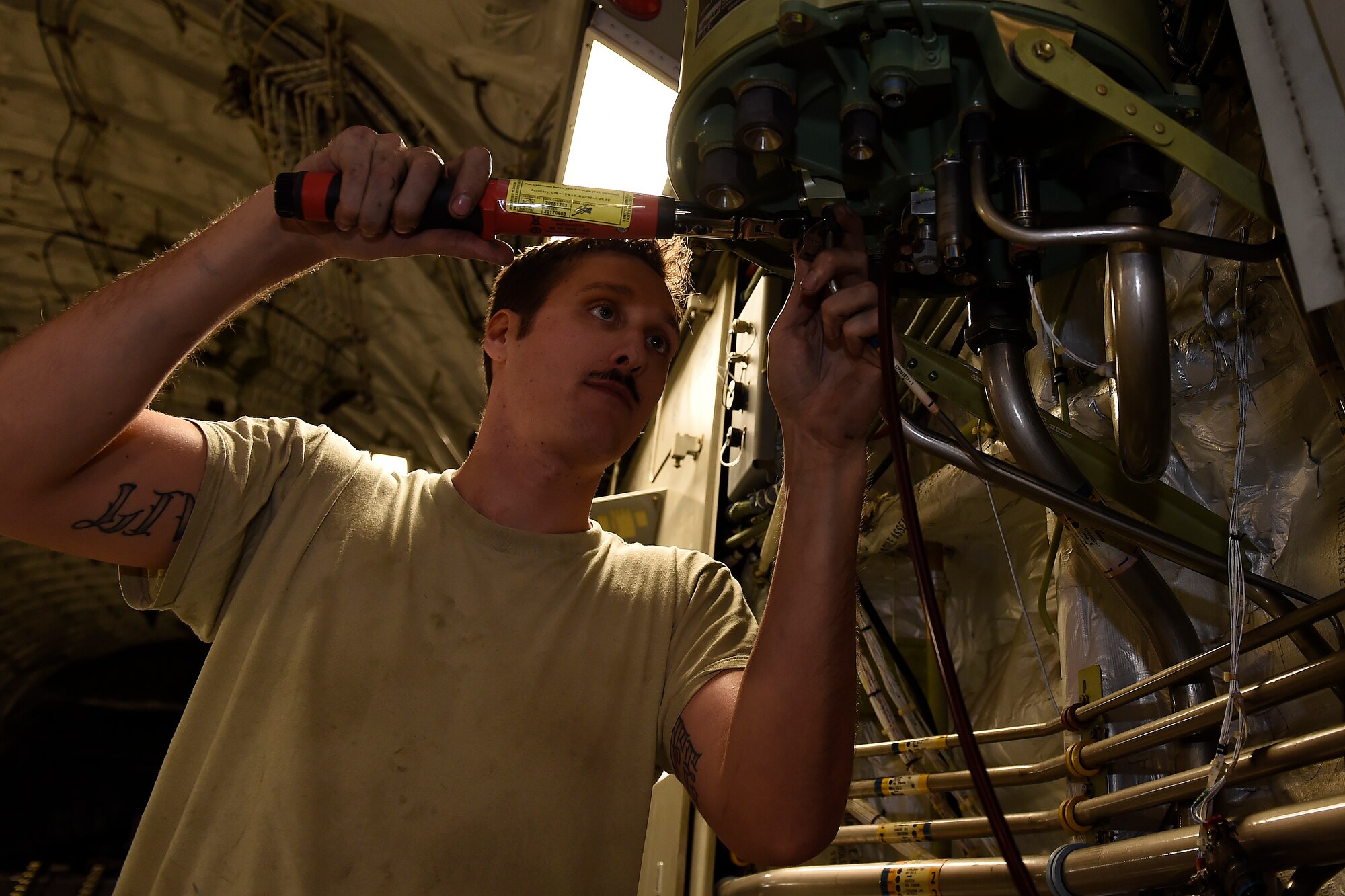 Staff Sgt. Nathan Kuhn, 62nd Maintenance Squadron hydraulics systems craftsman, installs a hydraulic reservoir on a C-17 Globemaster III, Feb. 18, 2016 at North Island Naval Station, Calif. Kuhn was the team lead for a four person McChord Maintenance Recovery Team sent from Joint Base Lewis McChord, Wash., to fix the broken reservoir. (U.S. Air Force photo/Tech Sgt. Tim Chacon)